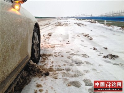 2月5日，S49高速路河南舞钢境内，车轮夹带积雪阻塞在底盘缝隙，行驶一会就需要停车清理。新京报记者 吴江 摄